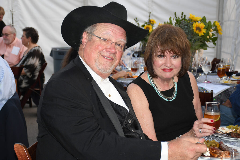 Man in cowboy hat and woman at Texas gala