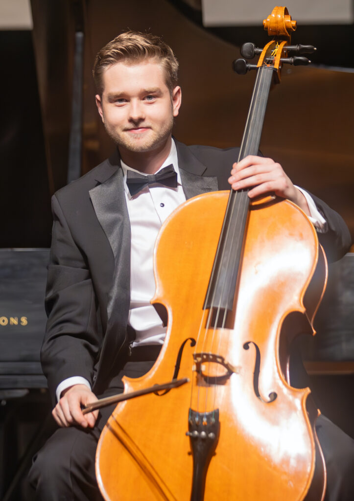 Performer poses with his cello