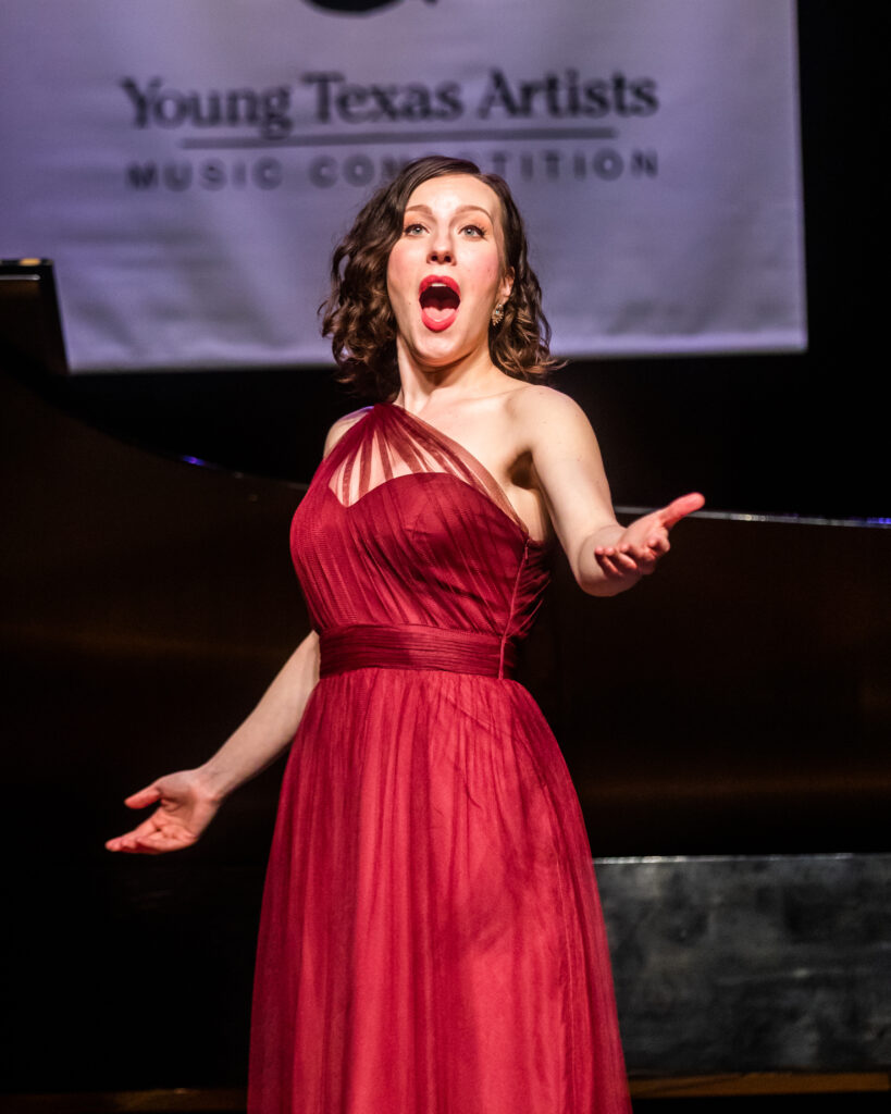 Woman in red sings at Young Texas Artists Music Competition